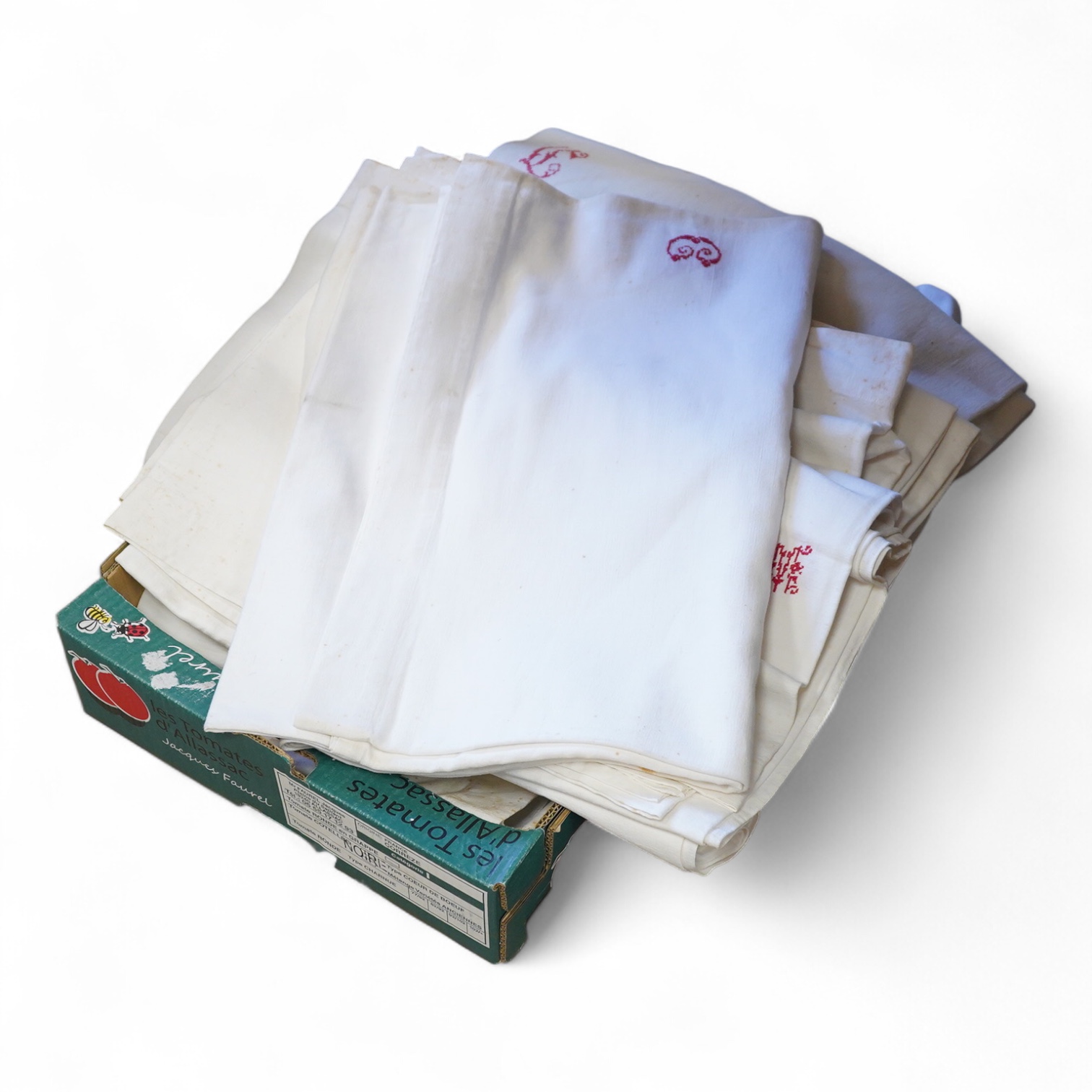 Six French provincial linen sheets each with a red cross stitched monogram to the turn back.